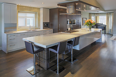 Inspiration for a mid-sized contemporary galley medium tone wood floor eat-in kitchen remodel in Calgary with an undermount sink, flat-panel cabinets, white cabinets, quartz countertops, yellow backsplash, glass tile backsplash, stainless steel appliances and an island