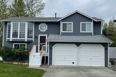 Example of a mid-sized trendy blue two-story concrete fiberboard and clapboard house exterior design in Seattle