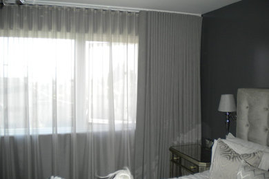 Inspiration for a large modern master bedroom remodel in Seattle with gray walls