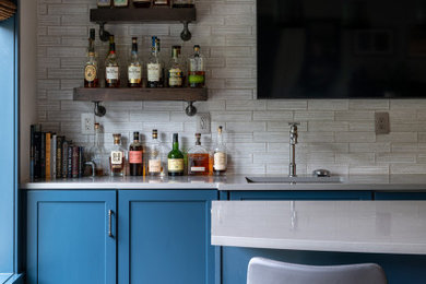Inspiration for a modern laminate floor basement remodel in Kansas City with a bar