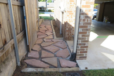 Example of a small mountain style side yard stone patio design in Oklahoma City