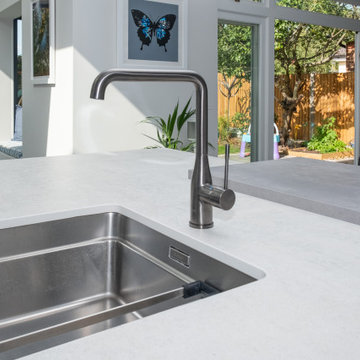 Handless Kitchen with Blue Splashback in Stanmore By Kudos Interior Designs