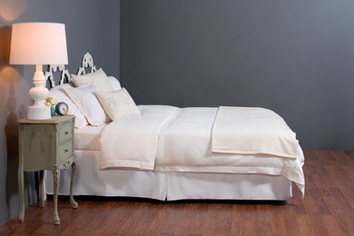 Mid-sized minimalist loft-style dark wood floor bedroom photo in Orange County with gray walls