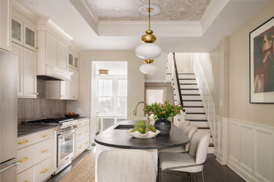 Eat-in kitchen - mid-sized traditional galley painted wood floor and tray ceiling eat-in kitchen idea in Philadelphia with an undermount sink, stainless steel appliances, an island and gray countertops