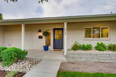 Example of a mid-century modern home design design in Denver