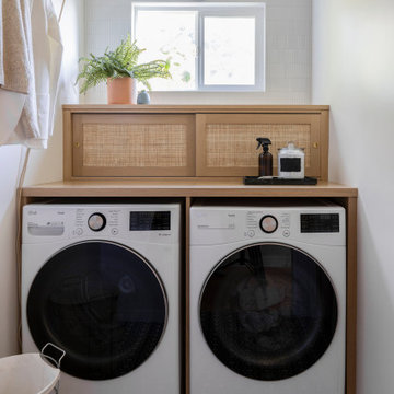 Laundry Room with Built-In Shaker Cabinets, Rattan Panels, and LG Washer & Dryer