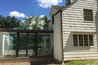 Photo of a transitional white exterior in New York with wood siding.