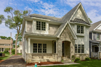 Inspiration for a large transitional white two-story concrete fiberboard house exterior remodel in Chicago with a hip roof and a mixed material roof