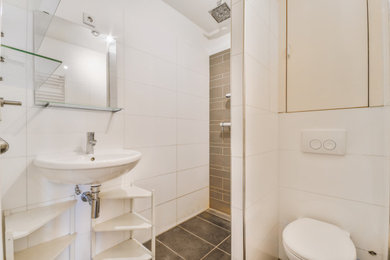 Example of a small minimalist white tile and subway tile gray floor and single-sink wet room design in Los Angeles with white cabinets, a wall-mount toilet, a wall-mount sink, white countertops and a floating vanity