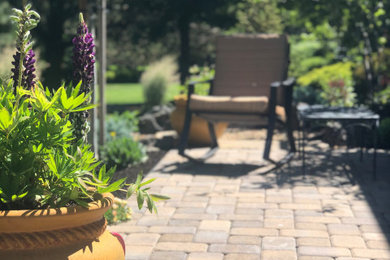 Elegant backyard concrete paver patio container garden photo in Other