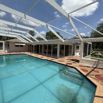Full installation of custom impact-rated sliding glass doors patio enclosure