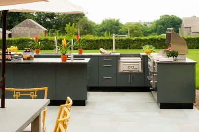 Inspiration for a mid-sized contemporary backyard concrete paver patio kitchen remodel in Orange County with no cover