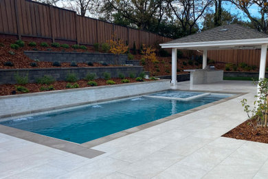 Pool landscaping - large contemporary backyard tile and rectangular pool landscaping idea in San Francisco