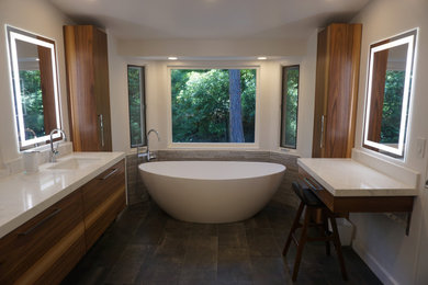 Design ideas for a large modern master bathroom in Los Angeles with flat-panel cabinets, medium wood cabinets, a freestanding tub, an open shower, a one-piece toilet, gray tile, porcelain tile, beige walls, porcelain floors, an undermount sink, quartzite benchtops, black floor, a hinged shower door, a niche, a double vanity and a floating vanity.