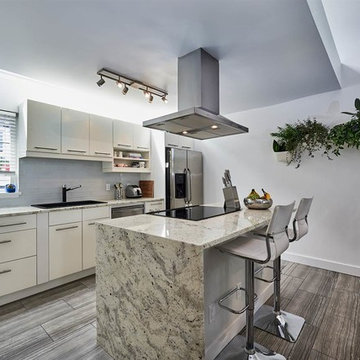 Open concept kitchen with marble counters and heated tile floors