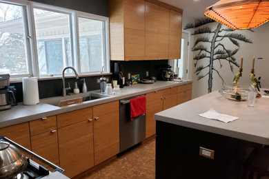 1950s kitchen photo in Grand Rapids with flat-panel cabinets, black cabinets, concrete countertops, slate backsplash and an island