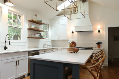 Example of a large medium tone wood floor and vaulted ceiling eat-in kitchen design in Charlotte with an undermount sink, shaker cabinets, blue cabinets, quartz countertops, white backsplash, subway tile backsplash, an island and white countertops