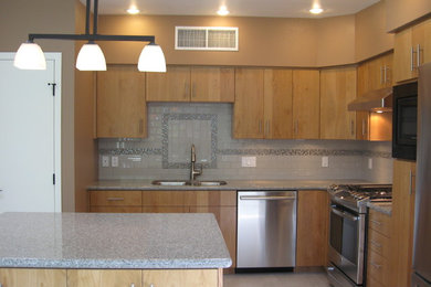 Mid-sized trendy l-shaped porcelain tile enclosed kitchen photo in Phoenix with an undermount sink, flat-panel cabinets, light wood cabinets, granite countertops, white backsplash, ceramic backsplash, stainless steel appliances and an island