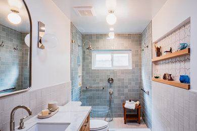 Example of a mid-sized beach style 3/4 multicolored tile and ceramic tile ceramic tile, white floor and single-sink bathroom design in Los Angeles with beige cabinets, a one-piece toilet, an undermount sink, quartzite countertops, white countertops and shaker cabinets