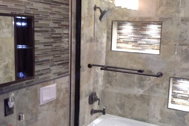 Bathroom - small modern 3/4 beige tile and porcelain tile porcelain tile bathroom idea in San Francisco with a vessel sink, a wall-mount toilet, dark wood cabinets, flat-panel cabinets, beige walls and solid surface countertops