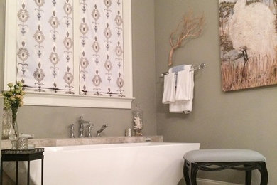 Example of a mid-sized transitional master freestanding bathtub design in Atlanta with gray walls