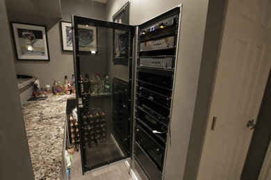 Photo of a small traditional wine cellar in Toronto with display racks.