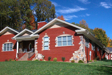 Mid-sized craftsman red one-story brick exterior home idea in Other with a shingle roof