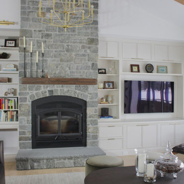 Custom-built entertainment center, white inset cabinetry and flat gold hardware.