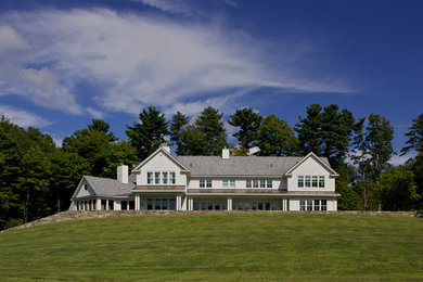 Large traditional white two-story vinyl gable roof idea in Boston