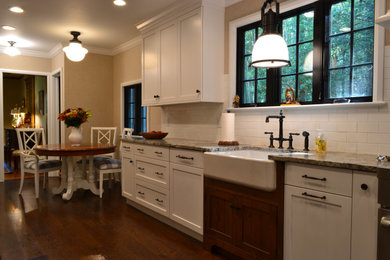 Eat-in kitchen - mid-sized traditional galley medium tone wood floor and brown floor eat-in kitchen idea in New York with recessed-panel cabinets, white cabinets, granite countertops, white backsplash, subway tile backsplash and beige countertops