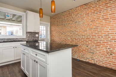 Example of a mid-sized transitional l-shaped dark wood floor open concept kitchen design in Baltimore with a double-bowl sink, shaker cabinets, white cabinets, quartz countertops, multicolored backsplash, matchstick tile backsplash, stainless steel appliances and an island