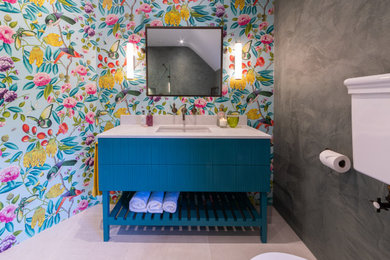 This is an example of a bohemian bathroom in London with blue cabinets, a walk-in shower, an open shower, a single sink and a freestanding vanity unit.