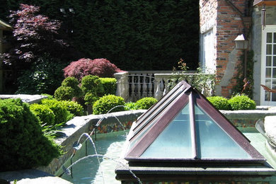 This is an example of a large traditional backyard landscaping in Vancouver.