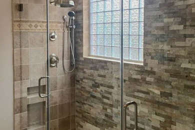 Inspiration for a mid-sized country master bathroom in Houston with a freestanding tub, an alcove shower, multi-coloured tile, mosaic tile, brown walls, mosaic tile floors, a drop-in sink, brown floor and a hinged shower door.