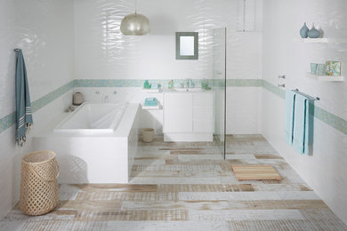 Photo of a mid-sized modern kids bathroom in Brisbane with an integrated sink, white cabinets, a drop-in tub, an open shower, multi-coloured tile, ceramic tile and white walls.
