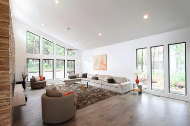Large trendy formal and open concept medium tone wood floor and brown floor living room photo in Orlando with white walls, a standard fireplace, a metal fireplace and no tv