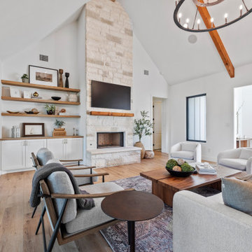 Modern Lakeside Farmhouse Living Room with Stone Fireplace and Natural Light
