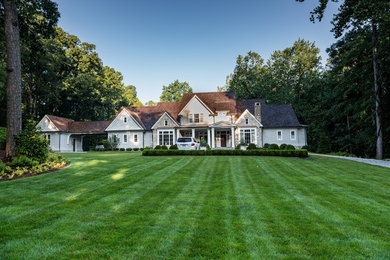 Photo of a large traditional partial sun front yard brick landscaping in Atlanta.