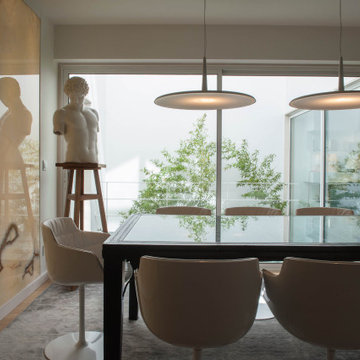 Parede dining room with stone table, sculpture and garden glazing
