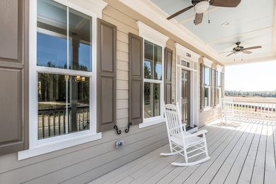 Example of a classic beige house exterior design in Raleigh
