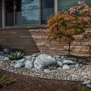 Small arts and crafts front yard full sun xeriscape in Other with river rock.