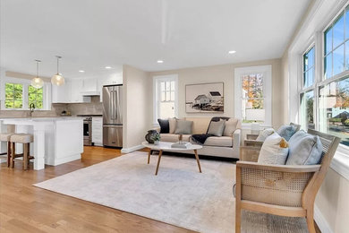 Family room - mid-sized transitional open concept medium tone wood floor family room idea in Boston with beige walls