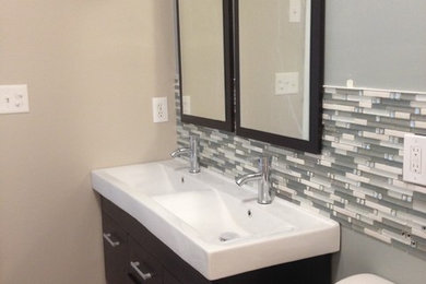 Mid-sized minimalist master gray tile and mosaic tile ceramic tile and gray floor bathroom photo in Wilmington with flat-panel cabinets, dark wood cabinets, marble countertops, a two-piece toilet, beige walls and an integrated sink