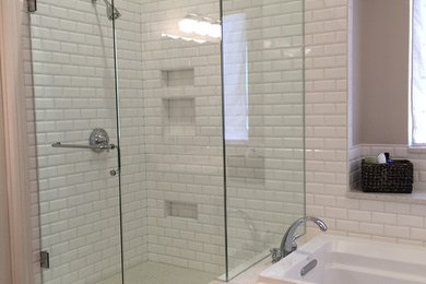 Example of a mid-sized beach style master gray tile and porcelain tile porcelain tile and brown floor bathroom design in Dallas with raised-panel cabinets, white cabinets, a one-piece toilet, gray walls, an undermount sink, quartz countertops and a hinged shower door