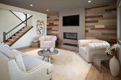 Minimalist open concept light wood floor family room photo in Edmonton with brown walls, a standard fireplace and a wall-mounted tv