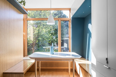 Example of a small trendy wood wall breakfast nook design in Toronto with blue walls