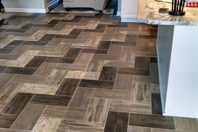 Inspiration for a mid-sized coastal vinyl floor and multicolored floor eat-in kitchen remodel in New York with stainless steel appliances and an island
