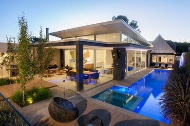 Inspiration for a large contemporary split-level grey exterior in Adelaide with a flat roof.