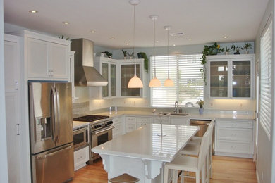 Small minimalist u-shaped light wood floor eat-in kitchen photo in San Diego with an undermount sink, white cabinets, soapstone countertops, stainless steel appliances, an island, shaker cabinets, gray backsplash and glass tile backsplash