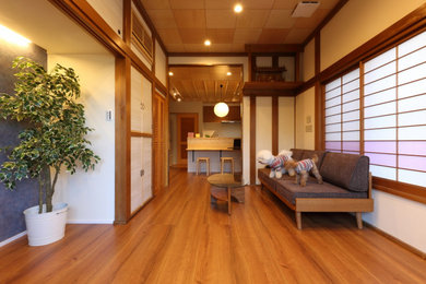 Photo of a modern enclosed living room in Other with plywood floors, no fireplace, brown floor and wood.